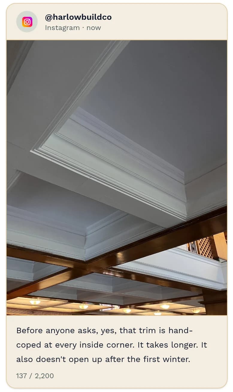 Instagram post preview from @harlowbuildco: white coffered ceiling trim over dark wood beams. Caption: “Before anyone asks, yes, that trim is hand-coped at every inside corner. It takes longer. It also doesn't open up after the first winter.” 137 of 2,200 characters.