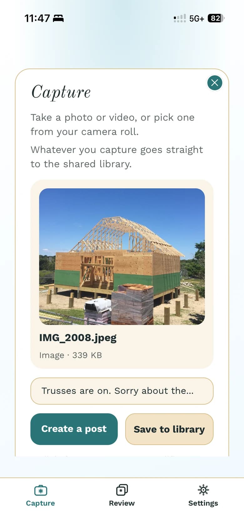 The phone app's Capture screen with a just-taken job-site photo of a house with its roof trusses on, the caption “Trusses are on. Sorry about the…”, and Create a post and Save to library buttons.