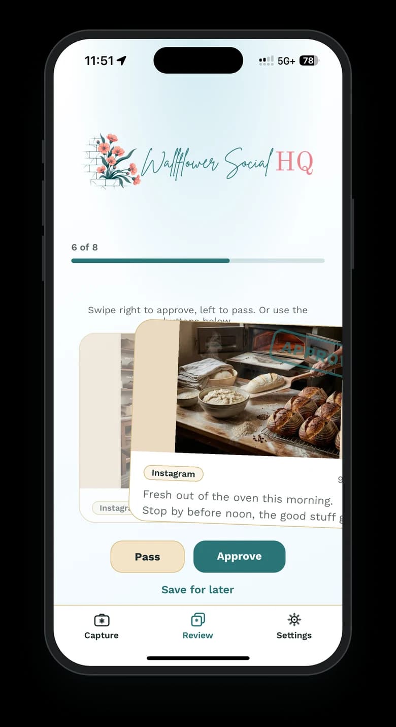 The Wallflower phone app on an iPhone, swiping right to approve draft 6 of 8 on the Review tab: an Instagram post with a photo of fresh sourdough loaves by the bread oven, captioned “Fresh out of the oven this morning. Stop by before noon…”, tilting away with an Approve stamp, and the next draft underneath.
