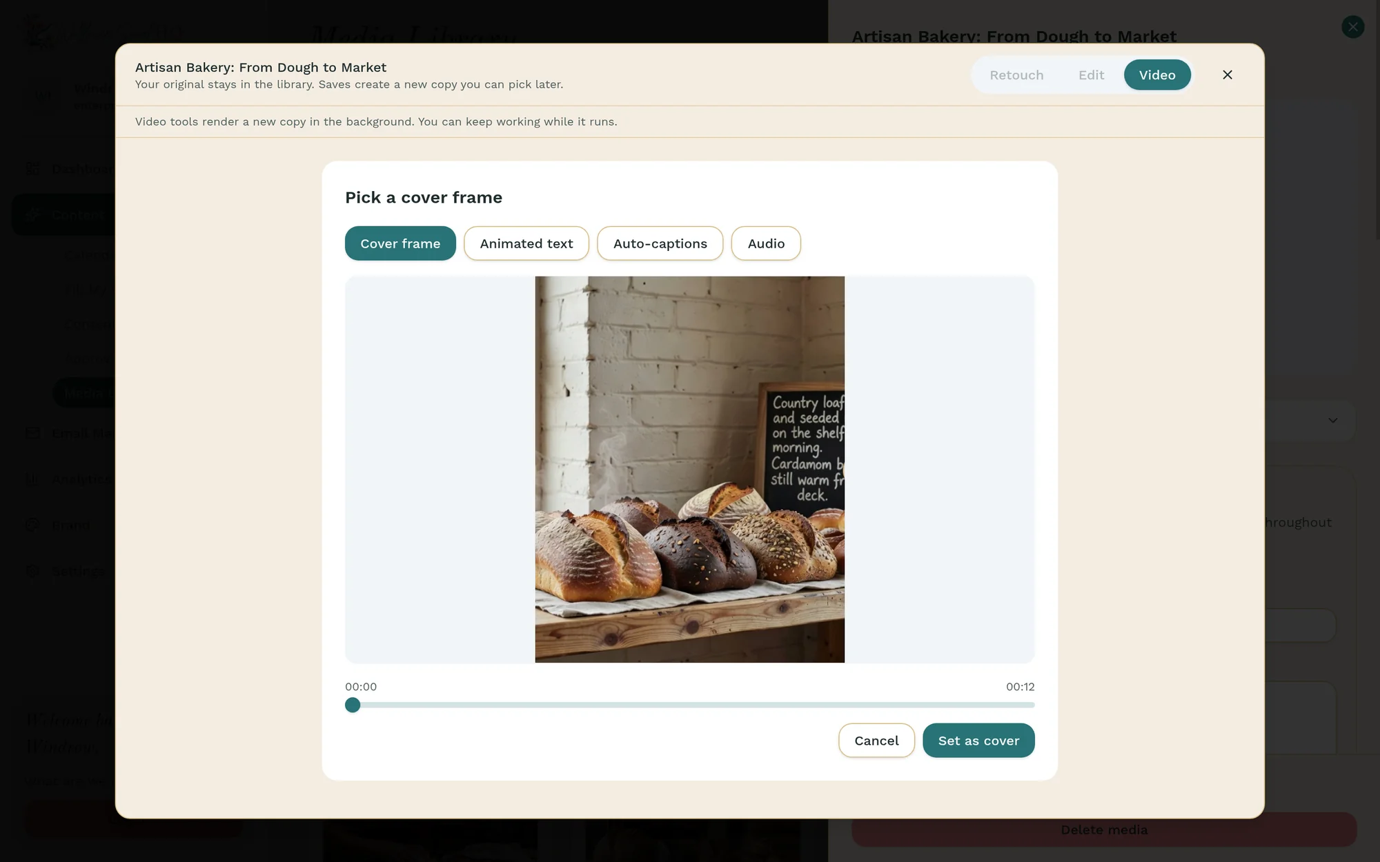 The video tools for a clip called “Artisan Bakery: From Dough to Market”, open to Pick a cover frame, with Cover frame, Animated text, Auto-captions and Audio tabs, a frame of sourdough loaves on a wooden shelf by a chalkboard, a 12-second timeline scrubber, and Cancel and Set as cover buttons.